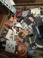 Photo showing an assortment of vinyl albums including those by George Michael, Tracy Chapman, Stevie Wonder, ABBA, Bee Gees, and more, spread on a floor.