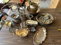 Overview of entire lot laid out on table showing all pieces in collection with tarnish and vintage design.