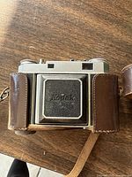 Front view of Retina IIIC camera inside brown leather case displaying Kodak logo imprint on case front.