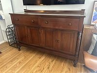 Full view of the buffet sideboard showing two drawers and two cabinet doors, wooden finish.
