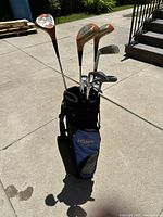 Full view of the blue Viper by Hippo nylon golf bag standing upright with multiple golf clubs inside, showing shoulder strap and front pockets.