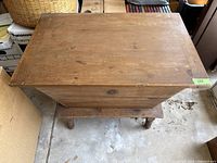 Top view of closed wooden storage box showing natural wood surface and compact rectangular shape.