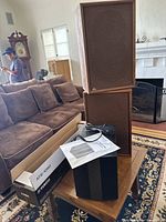 Yamaha ATS-1080 sound bar box, Proficient PS8 subwoofer, Quadraflex Q3 speakers and manual on wooden table.