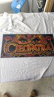 Full view of slot glass panel showing entire Cleopatra themed artwork in bold colors.