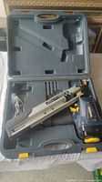 Mastercraft framing nailer and accessories arranged inside open black molded plastic tool case