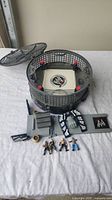 The complete WWE wrestling cage playset with the steel cage, ramp, vest accessory, and four action figures arranged on a white surface.