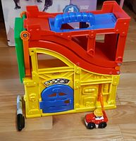 Front view of garage with car and scale marker