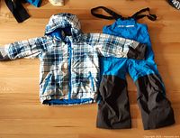 Front view of jacket and snow pants laid out