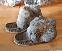 Side view of both mukluks showing grey rabbit fur and suede construction