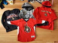 All four Ottawa Senators tops arranged on floor