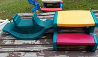 Picnic table and seesaw side by side on deck