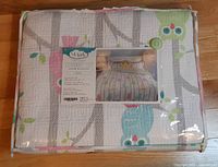 Front of packaged twin coverlet set showing label and owl pattern