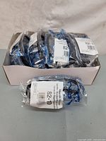 Box containing 12 individually packaged pairs of adjustable safety glasses.