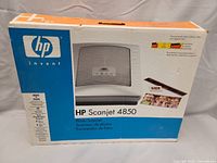 Photo of the HP Scanjet 4850 original box showing the front view and product image, including branding and specifications.