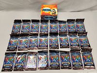 Photo showing Lightseekers Awakening booster box and 24 single booster packs laid out on a surface.