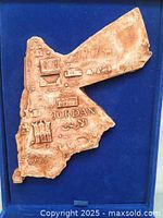 Close-up of the decorative map showing Arabic text and landmarks relief detail.