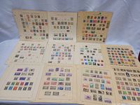 Ten album pages with assorted stamps visible, mounted on grid-format sheets.