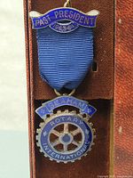 Full medal with blue ribbon and enamel badge showing Past President 1963-64 banner and Seaham Rotary International gear-wheel emblem.