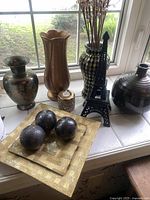 Overview of all items including vases, plates, decorative balls, Eiffel Tower figurine, and candle holder arranged on window sill.