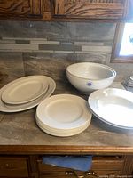 Photo showing entire dish set with plates, nesting bowls, large shallow bowls, and platters.