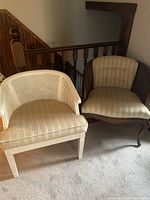 Pair of vintage armchairs side by side, one white and one brown, showing overall condition and style.
