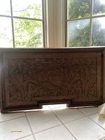 Photo of vintage wooden carved wall decor panel showing detailed floral and heart carvings with light wear.