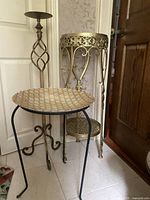 Four vintage metal stands together showing candle holder, gold plant stand, glass bird bath on wrought iron stand, and smaller white decorative stand.