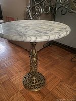 Full view of round marble top and brass base