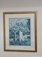Framed large monochromatic blue print showing a woman standing under a tree in a natural setting.