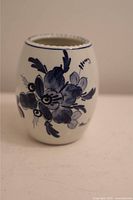Front view of the small oval Delft bud vase showing blue hand-painted floral design on white ceramic.