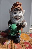 Front view showing the gnome's face, hat, watering can and smiling expression.