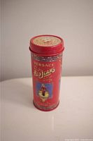 Front view of the vintage Versace Red Jeans perfume tin, showing the main label and image of a woman.