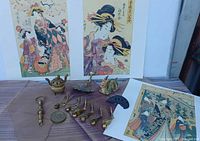 overview showing three prints and assortment of brass pieces