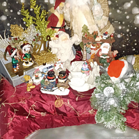 Overview of lot showing Santas, Disney ornaments, candle holder, shakers, stocking holder