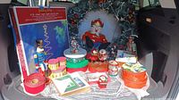 Full lot showing wreath, plush snowman, nutcrackers, light kit, tins, ribbon, globes, cards