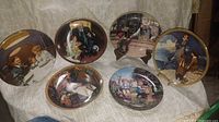 Group shot of six decorative plates in lot