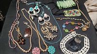 Full layout of all jewelry pieces on dark background