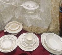 Group shot of entire china set showing tureens, plates, bowls, cup and serving pieces