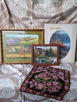 Group shot of all four items: Darrell Bush print, farm print, cabin print, tapestry
