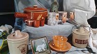 Group shot showing Mexican pot, cups, rabbit tealight, owl mug, crocks, tile, amber cup and saucer
