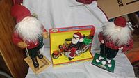 All three Santa figurines grouped together