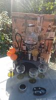 Overall lot showing glass dispenser, three goblets, accessories and box