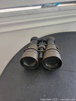 Antique binoculars showing front lenses and leather with brass barrels