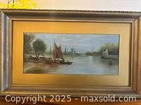 Full view of the framed antique oil painting showing ships in a harbour with distant land and trees.