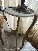 Round table with Carrara marble top, metal tray rim and handle, distressed green legs and base visible