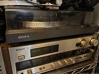 Front view of receiver with knobs and display, turntable on top