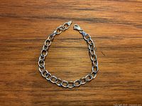 Bracelet laid flat on wooden surface showing full length