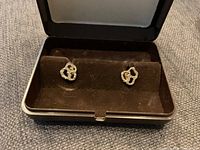 Pair of 14K gold abstract stud earrings in black velvet box