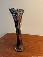 Full view of the 11.5 inch tall Boggy Bayou carnival glass vase highlighting fluted, scalloped rim and iridescent surface