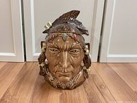 Front view of the vintage McCoy Pontiac Indian Chief cookie jar showing detailed facial features and word 'COOKIES' on the front.